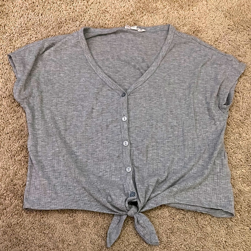 Women’s button v-neck shirt/blouse. Grey color with tie at the bottom.